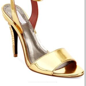 Gold High Heel with geometric detailed heel. Worn to one event.